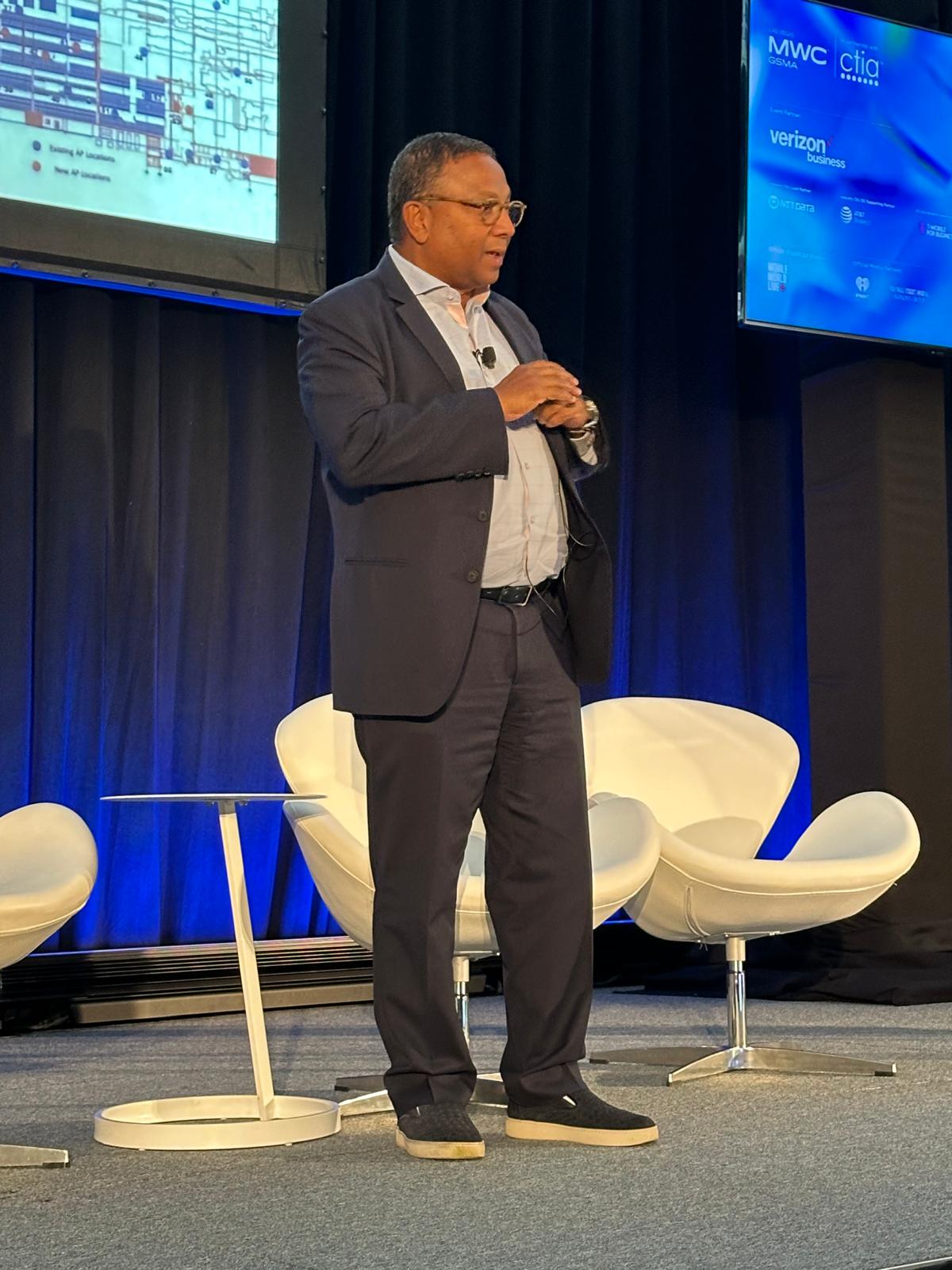 Side profile of Suvajit Basu speaking at MWC